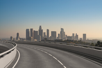 Fototapeta premium Empty urban asphalt road exterior with city buildings background. New modern highway concrete construction. Concept of way to success. Transportation logistic industry fast delivery. Los Angeles. USA.