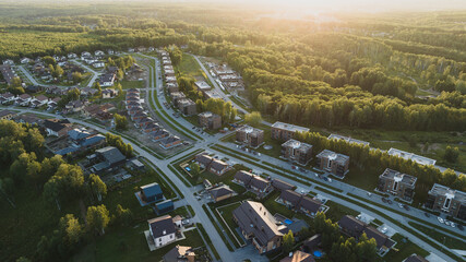 Small modern village in summer at sunset. Aerial view