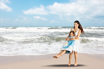Fototapeta na wymiar Happy mother with cute little girl on white tropical beach. Cheerful woman running along beach