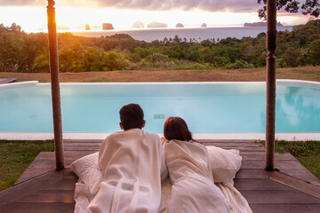 Happy Couple traveler enjoy Beautiful ocean view, Tourists relaxing in tropical luxury resort with...