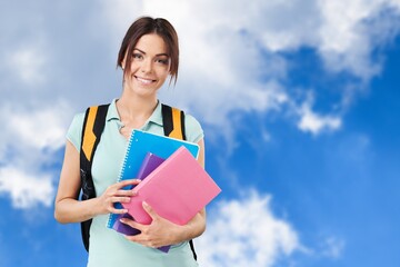Obraz premium Young student woman wearing backpack and holding books