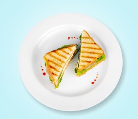 Delicious toasted sandwiches with cheddar cheese and bacon on the plate