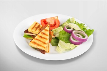 Delicious toasted sandwiches with cheddar cheese and bacon on the plate