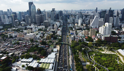Drivers navigate through Chaloem Maha Nakhon Expressway avenue in downtown Bangkok, Thailand. Benjakitti public park is seen on the right.