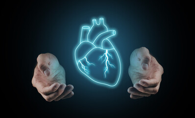 Virtual hologram human heart between doctor's hands on black background demonstrates heart health and cardiology care in healthcare. Heart health concept