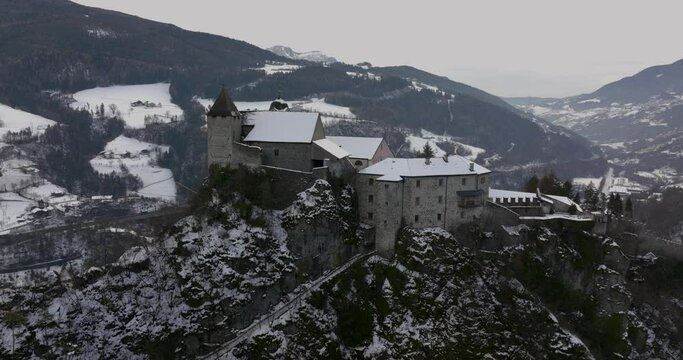 Camera crane movement that shows Monastero di Sabiona from above.