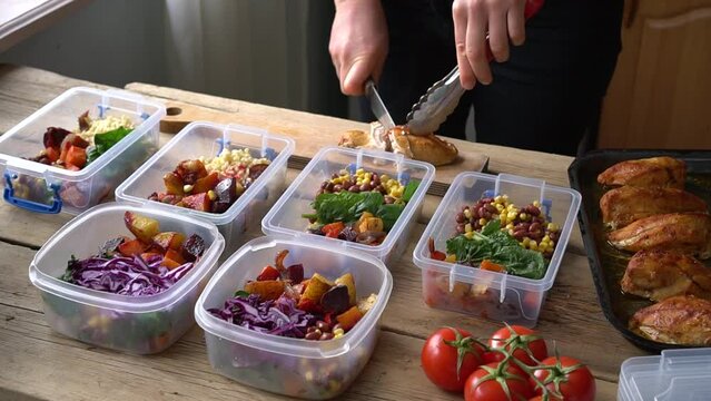Meal prep. Homemade takeaway food in plastic containers. Woman cooks healthy office lunch portion at home. Keto diet