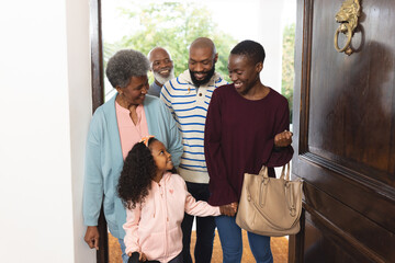 Image of happy multi generation african american family entering house