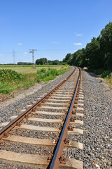 Fototapeta na wymiar Railway track next to a woods outside the city