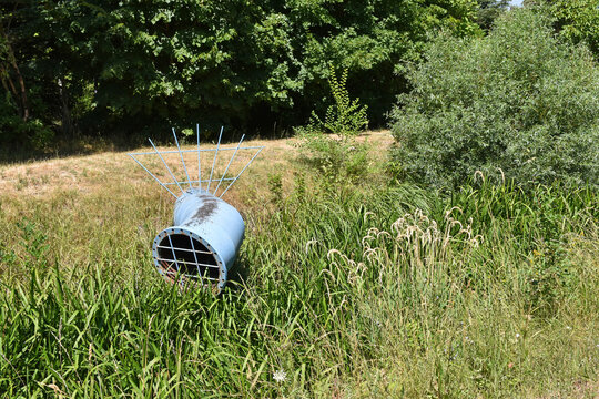 Sewage pipe on the meadow summer time