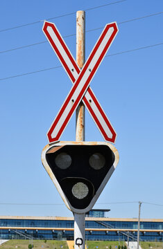 Railway crossing with light and cross sign