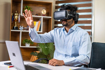 young businessman busy using VR or virtual reality headset for meeting at office with hand gestures...