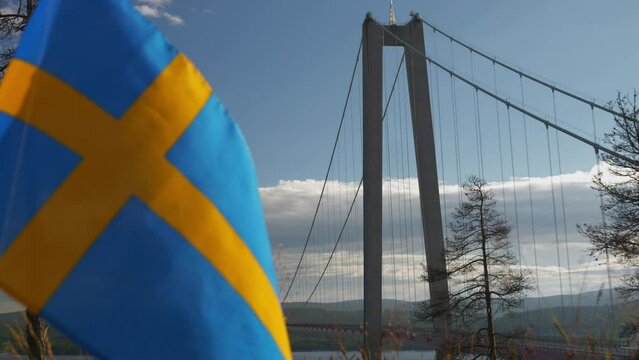 High Coast bridge and landscape behind the Swedish flag, H&ouml;ga kusten Sweden