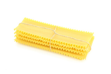 Uncooked lasagna sheets isolated on white background