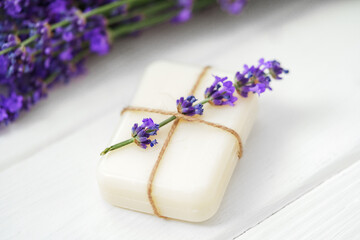 Obraz na płótnie Canvas Natural cube of lavender soap on white wooden background