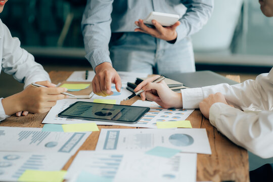 The atmosphere in the meeting room where the businessmen are meeting, information papers and charts are placed on the table to support the business planning meeting to grow. Business idea