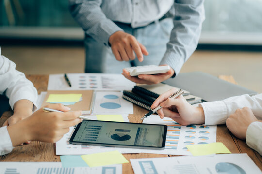 The atmosphere in the meeting room where the businessmen are meeting, information papers and charts are placed on the table to support the business planning meeting to grow. Business idea