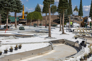 Arrangement of the park area. Park construction. Workers are engaged in landscaping.
