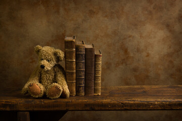 Books and teddy on wooden shelf