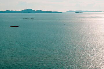 Sea and blue sky on the mountain background.