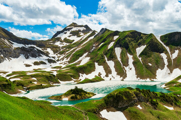 Beautiful thawing mountain lake Schrecksee in spring. Alpine landscape with mountains and snow. Allgau Alps, Bavaria, Germany