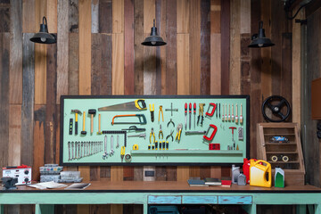 Fototapeta na wymiar Tools hanging on wall in workshop ,Tool shelf against a wall. Garage workshop with tools & equipment.
