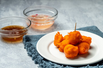 Tokneneng or tukneneng is a tempura-like Filipino street food made by deep-frying orange batter...