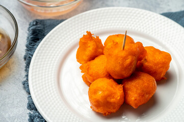 Tokneneng or tukneneng is a tempura-like Filipino street food made by deep-frying orange batter covered hard-boiled chicken or duck eggs. A popular variation of tokneneng is kwek kwek. 