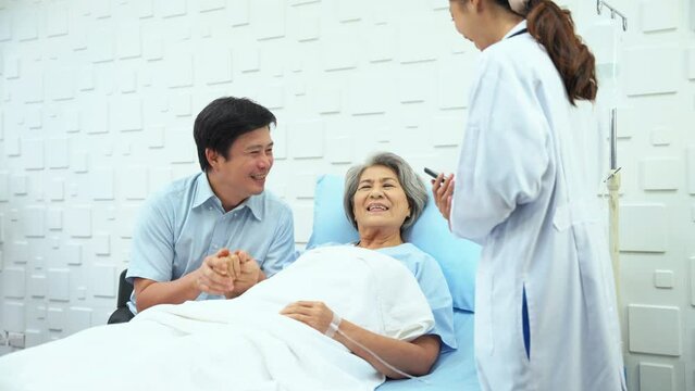 Female doctor said the results of the treatment improved. elderly female patient and her son is rejoicing. Female doctor smiled brightly when she saw the patient not worrying.