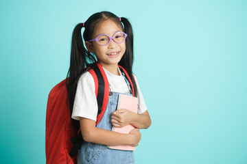 Kid students girl smiling holding book, going to school.