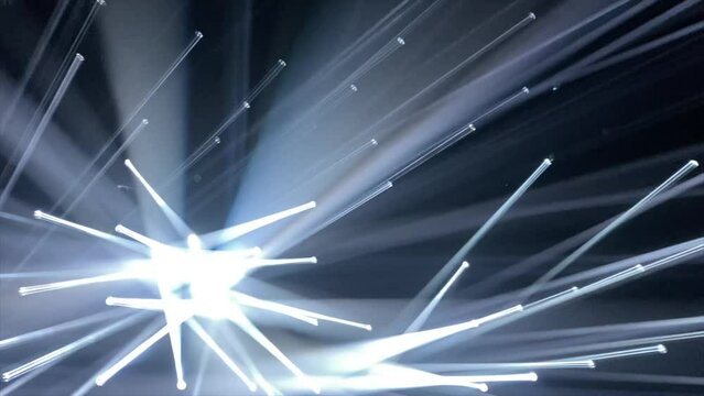 Dozens of sharp white light beams move through a dark space in a club-like setup. An amazing light show creating an abstract background scene. 