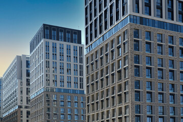 Exterior of a modern building house object with texture walls and windows. Luxury modern tall block of flats without balconies. Living apartments or office building. Real estate concept.