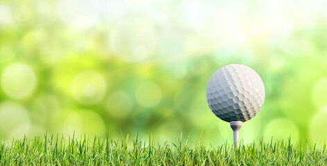 Golf ball on tee with grass and green blurred background - 3D Illustration - obrazy, fototapety, plakaty