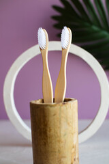 Eco friendly bamboo toothbrush with bathroom towel and red ribbon on white background, Bathroom accessories; personal hygiene; dental and oral care. zero waste concept