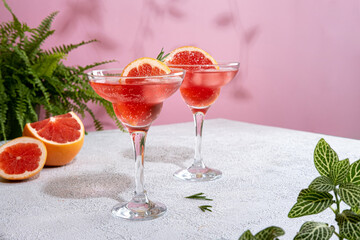 Summer refreshing sparcling cocktails with grapefruit. Lemonade garnished with fresh rosemary. Summer beverage with sparkling water and grapefruit slices.
