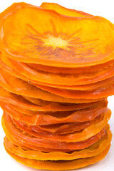 dried chopped persimmon, lined with a pyramid, close-up, on a white background