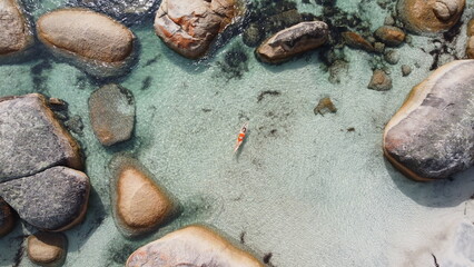 Aerial picture of a girl swimming in a fairy pool in Albany, Australia. Shallow and transparent...