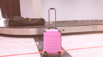 Pink Suitcase  as luggage on the belt in the Airport