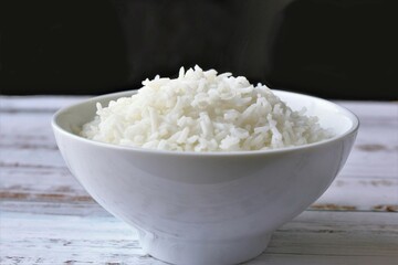 bowl of white rice photo on black background copy space 