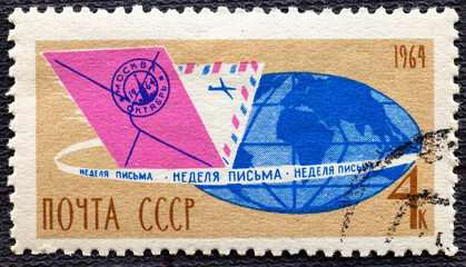 USSR - CIRCA 1964: A stamp printed in the USSR showing globe with envelope, circa 1964