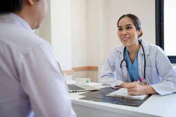 Professional doctor explain the results of a physical examination to  patient and advice on medication. Female doctor talks and records the patient's symptoms. Hospital , medical, health care