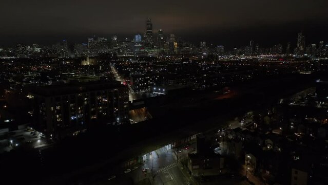 Drone shot of Urban Skyline of Chicago at Night time in USA. Aerial shot over residential houses and office buildings at dark.