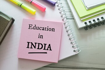 Sticky note pile with the text Education in India on desk. 