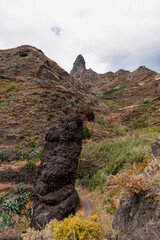 Panoramic view on El Dedo del Roque Pai crag, Roque Paez in Anaga mountain range, Tenerife, Canary Islands, Spain, Europe. Scenic hiking trail from mountain village Afur to Taganana. Canyon Barranco