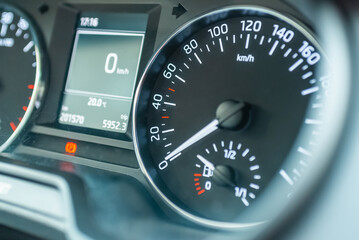 Fototapeta premium Modern car speedometer,odometer,tachometer and illuminated dashboard. car dashboard modern automobile controlilluminated panel speed display.Car instrument panel.Close up.Selective focus.