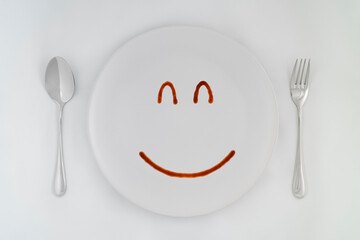 Smiling faces sauce on a white plate.Smiling symbol. Enjoy eating concept.