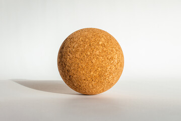 Nice brown cork ball lie on the white gray background,close up.