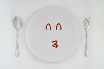 Smiling faces sauce on a white plate.Smiling symbol. Enjoy eating concept.