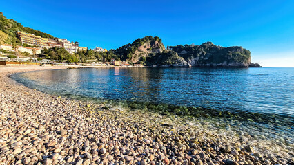 Panoramic view from beach Spiaggia di Isola Bella on paradise resort peninsula in Taormina, Sicily,...