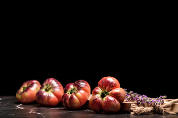 Still life with tiger tomato on wood table.